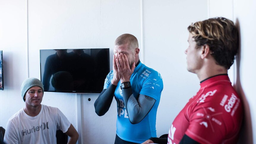 Shark scare ... Mick Fanning holds his head in his hands in disbelief following the attack at Jeffreys Bay