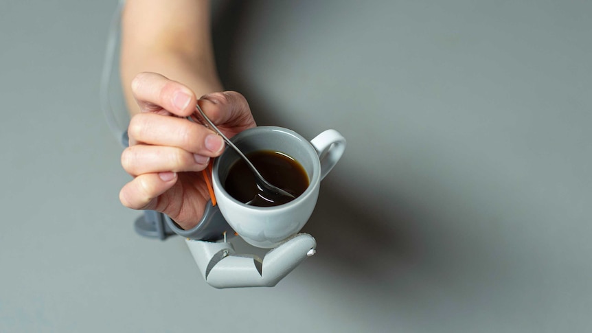 The third thumb allow the wearer to both hold a cup of coffee and stir it with one hand
