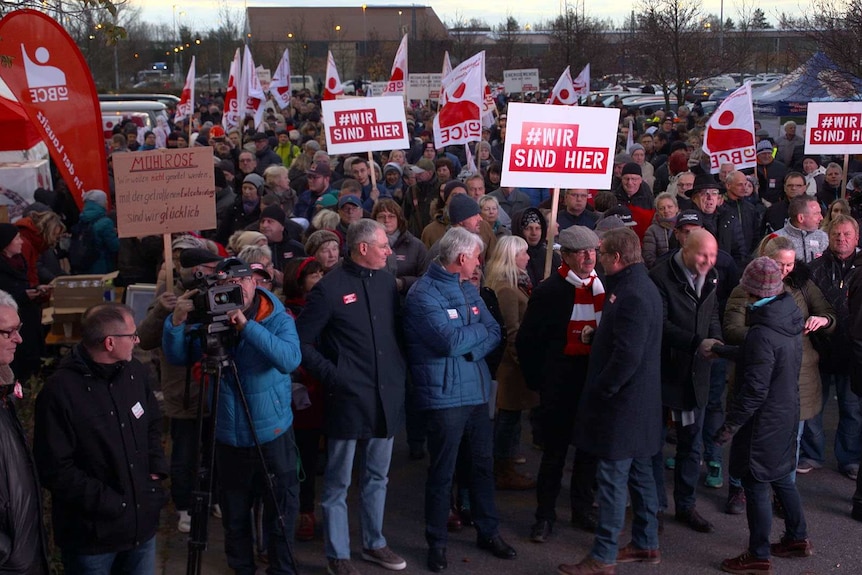 Workers gather with placards to show supports for the coal industry.