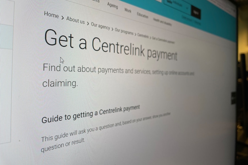 A mouse curser hovers over a screen that shows the Services Australia's 'Get a Centrelink payment' website. 