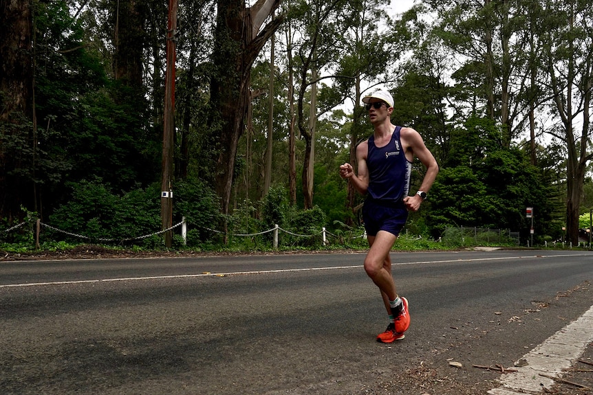 Olympic speedwalker Rhydian Cowley powers along a road in Victoria's Dandenong Ranges