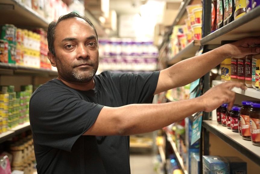 a man packing grocery store shelves