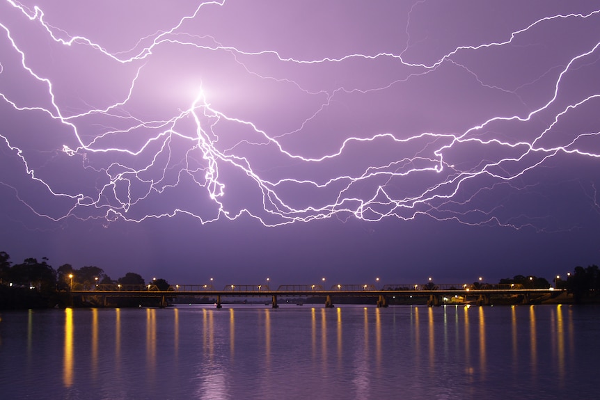 Lightning stretches across the sky over the Nowra bridge.