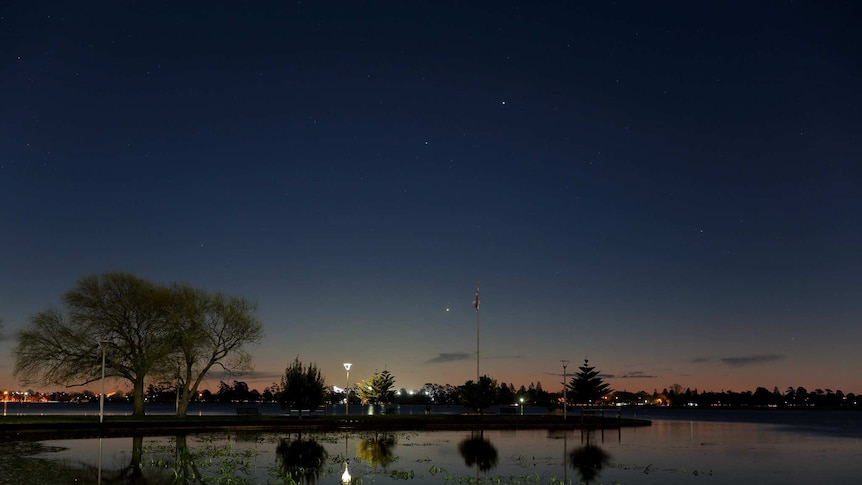 Evening over Lake Wendouree with stars visible in the sky, and reflected in the lake's surface.