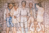 A painting of six men in white clothing and shackles, inside a cell