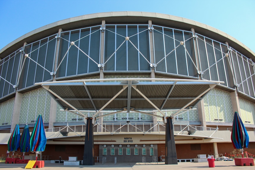 The exterior of a sports arena with sunny skies above 
