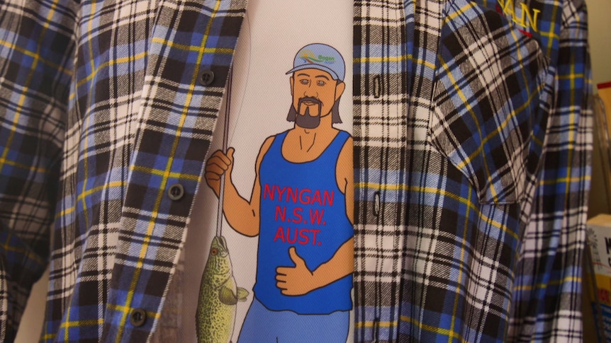 A flannelette shirt hangs over the top of a Big Bogan singlet on a mannequin.