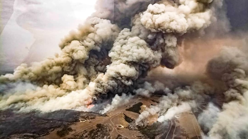 An aerial view of grey and greenish smoke from a bushfire on Kangaroo Island