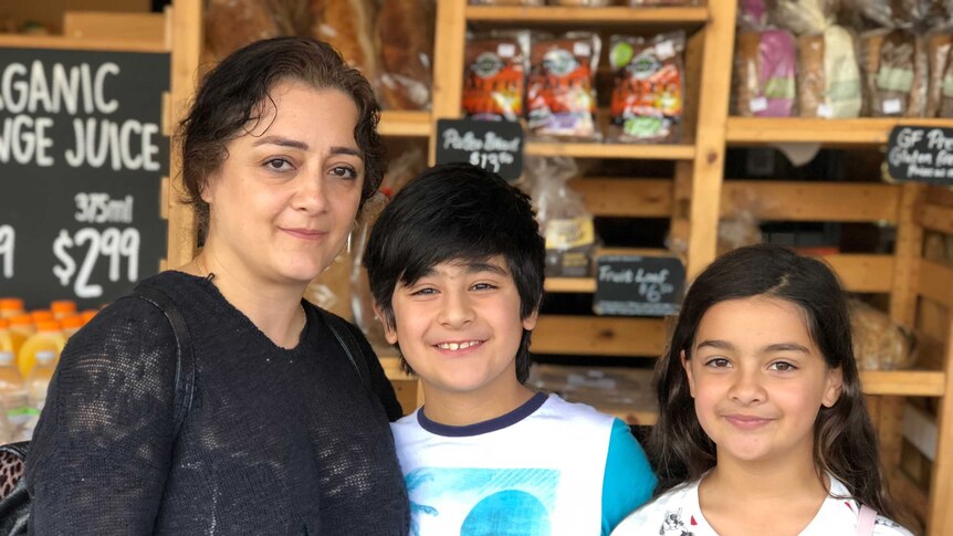 Nassie Shirazi with children Surena (left) and Roxana (right) shopping at the South Melbourne Market.