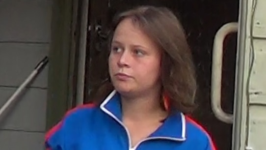 young girl with brown hair in a blue jacket