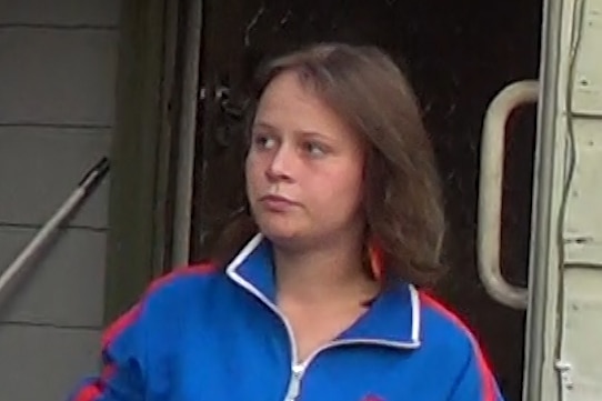 young girl with brown hair in a blue jacket
