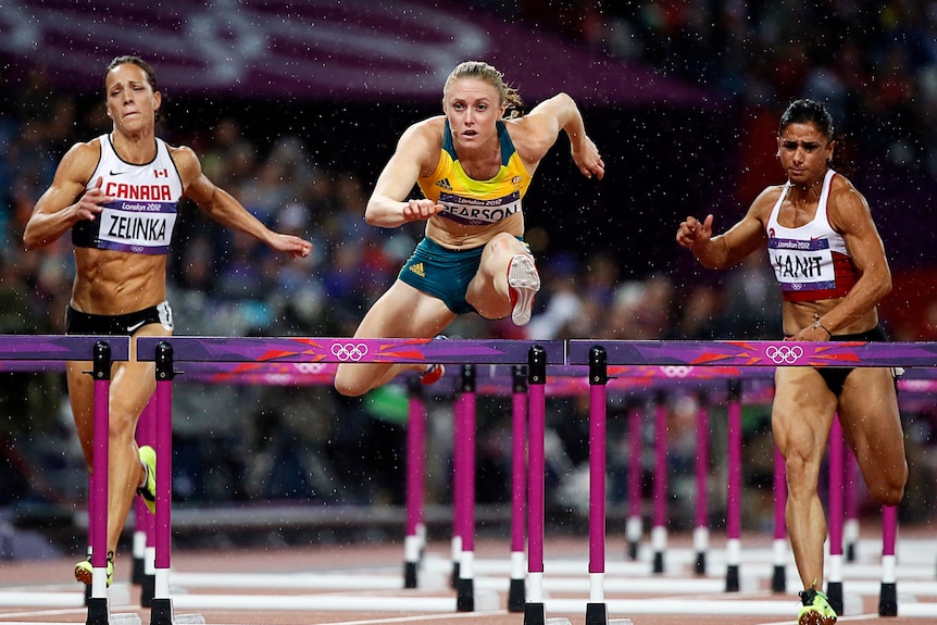 Australia's Sally Pearson wins the 100m hurdles final as rain tumbles down at the Olympic Stadium.