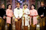 A group of people pose at an Indonesian wedding 