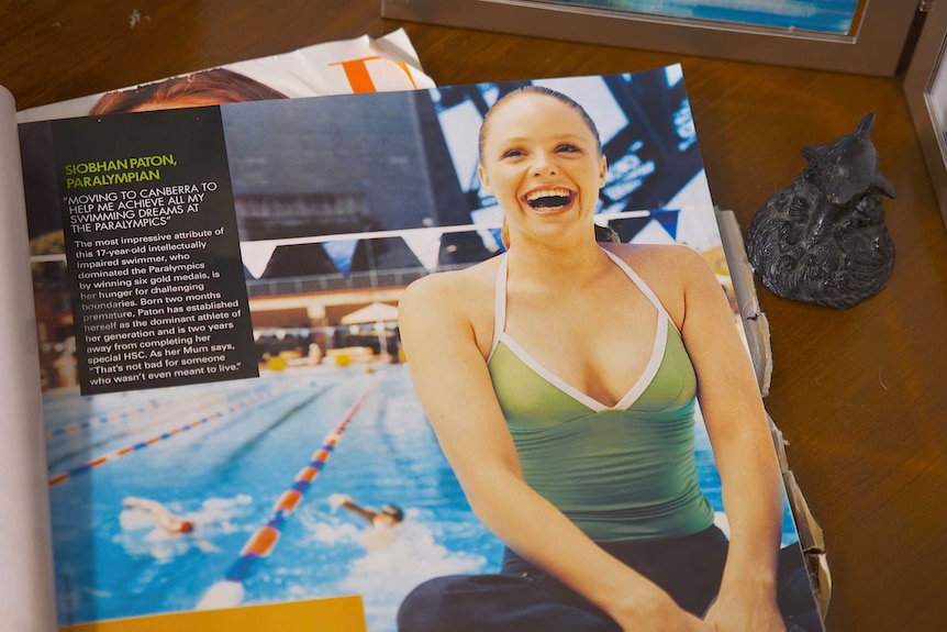 A photo of a magazine clipping, showing a young Siobhan smiling by the pool.