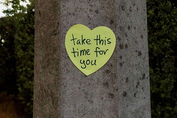 A post-it note on a lamp post says 'take this time for you'