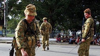 Australian peace keeping troops collect weapons from detain militiamen