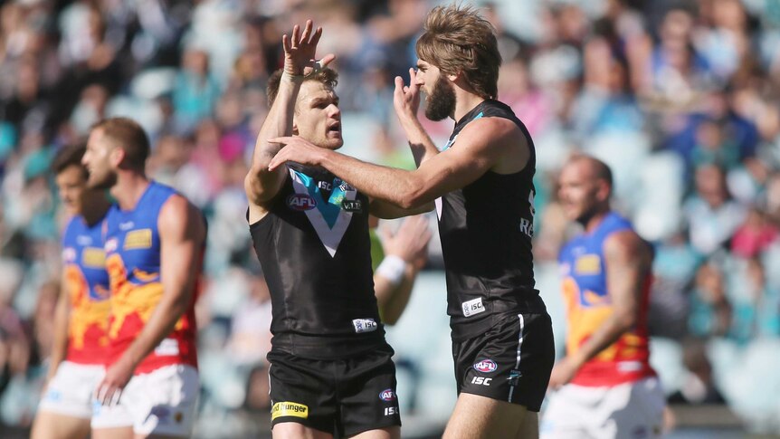 The Power's Justin Westhoff (R) is congratulated by Jackson Trengove after scoring against Brisbane.