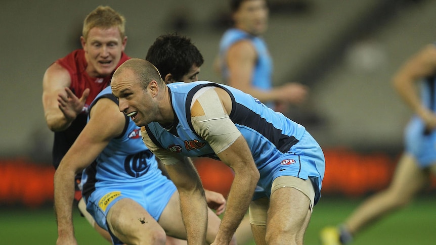 Leading by example: Chris Judd (31 touches, 12 tackles) looks to distribute the ball.