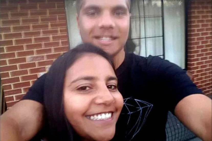 Stanley takes a selfie with his sister Jacinta Miller smiling and standing between his arms.