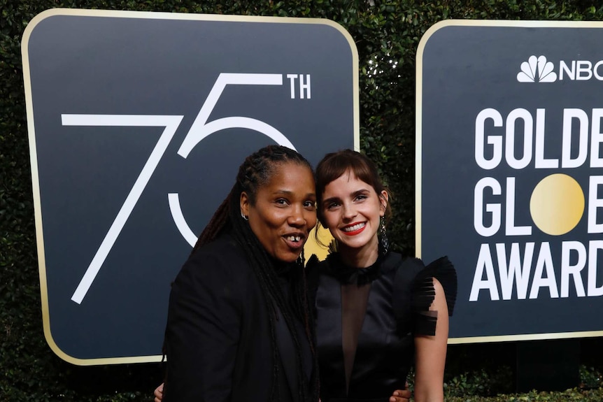 Emma Watson and activist Marai Larasi  both wearing black