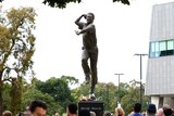 A statue of Shane Warne in his bowling action outside the MCG.