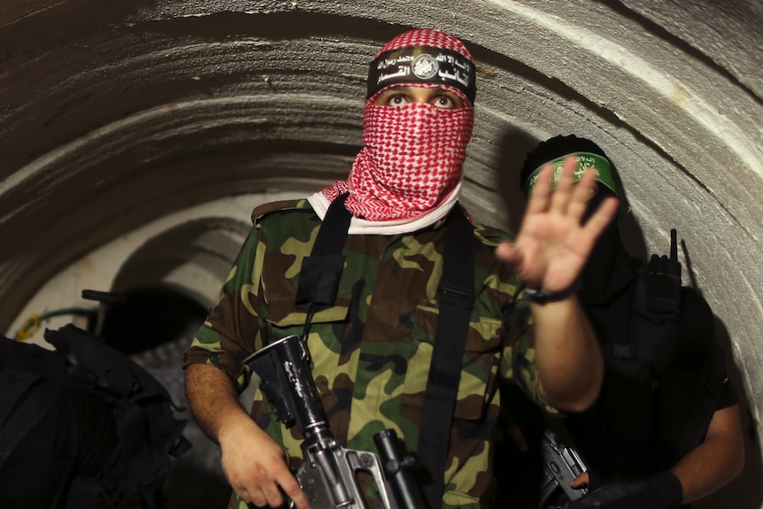 A Hamas fighter gestures inside an underground tunnel in Gaza.