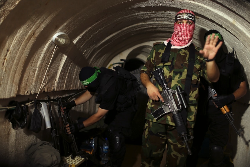 A Hamas fighter gestures inside an underground tunnel in Gaza.