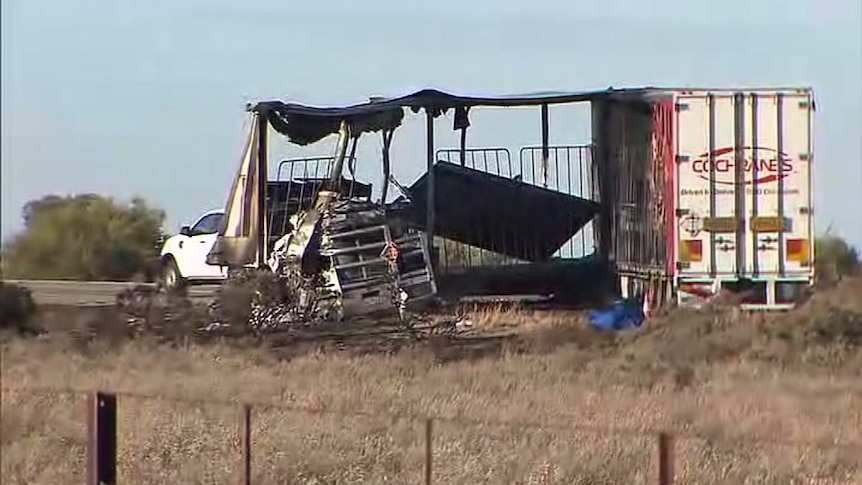 The burnt out shell of a truck trailer.