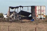 The burnt out shell of a truck trailer.