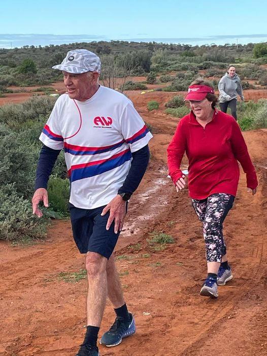 Ronald Perry walks on red dirt in Broken Hill as part of parkrun.