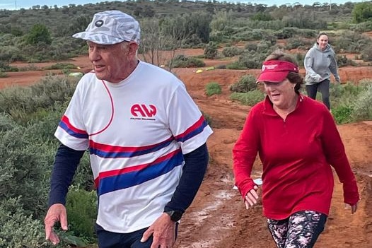 Ronald Perry walks on red dirt in Broken Hill as part of parkrun.