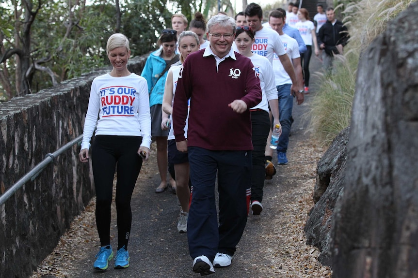 Prime minister Kevin Rudd and supporters walk along the Brisbane River in 2013.