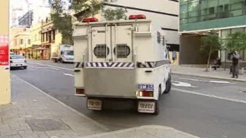 A police vehicle with Cameron Mansell inside arrives for his Perth court appearance.