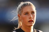 Tayla Harris in Carlton kit looks on during an AFLW match
