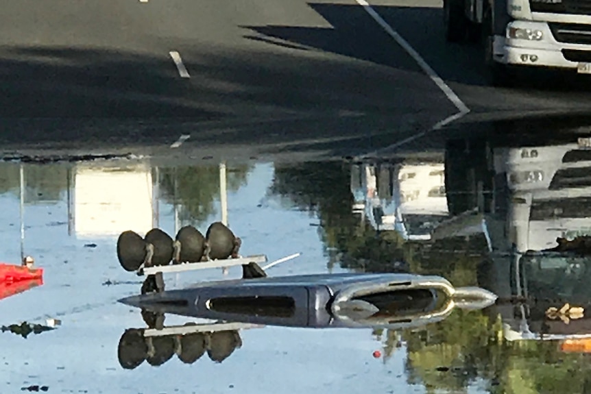 Submerged four-wheel drive in flooded Beenleigh street, south of Brisbane