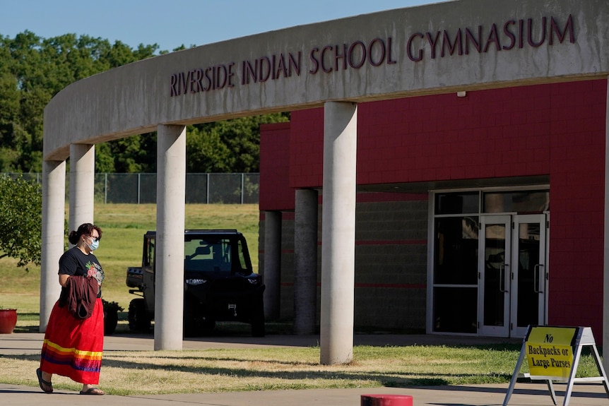 A woman walks into the Riverside Indian School Gymnasium.