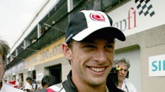 Thumbs up ... Jenson Button shows his delight at taking pole in Montreal