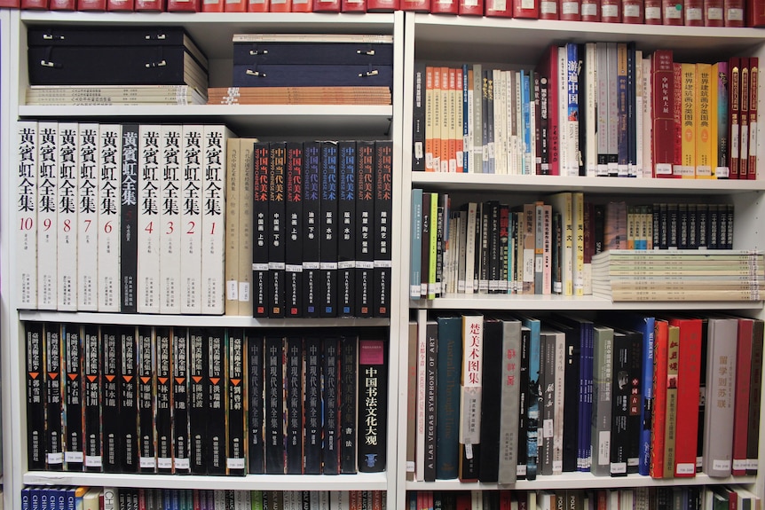 Chinese books on a book shelf. 