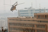 Soldiers enter a hospital under siege in Kabul from the roof after being dropped off by a helicopter.