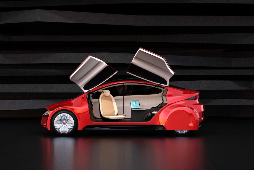 The side view of an autonomous car with doors that open upwards, the seats are turned to face each other.