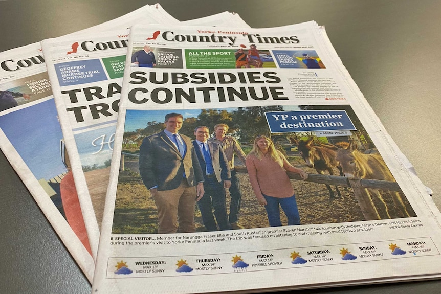 Three Yorke Peninsula Country Times newspapers sit on a table, with Fraser Ellis and Steven Marshall pictured on one front page