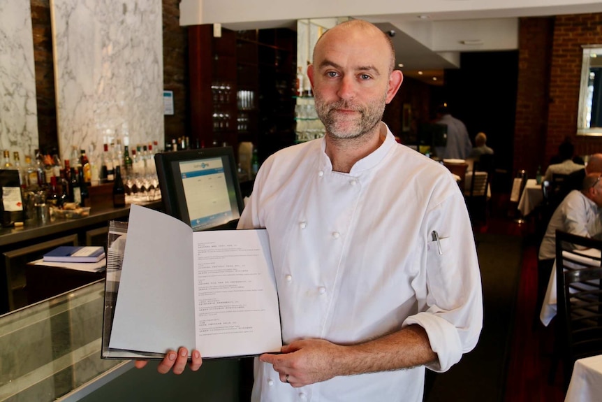 Tobias Gush holds the Chianti menu