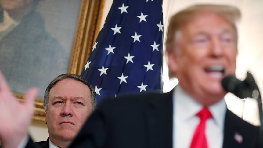 US Secretary of State Mike Pompeo listens as US President Donald Trump speaks