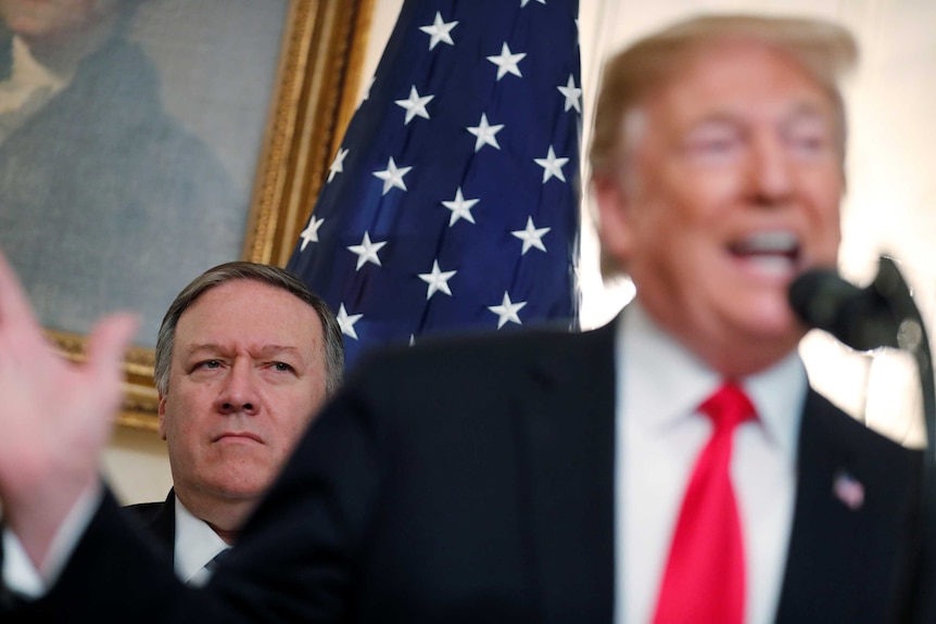 US Secretary of State Mike Pompeo listens as US President Donald Trump speaks