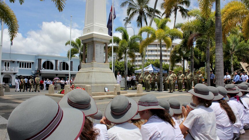 Schoolchildren watch the Remembrance Day Service in Cairns.