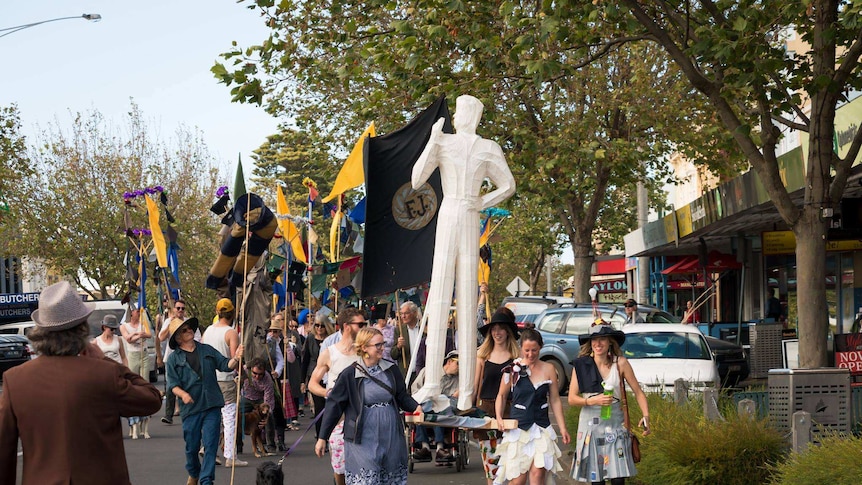 Young people parade a sculpture and clothes down Warrnambool's main street