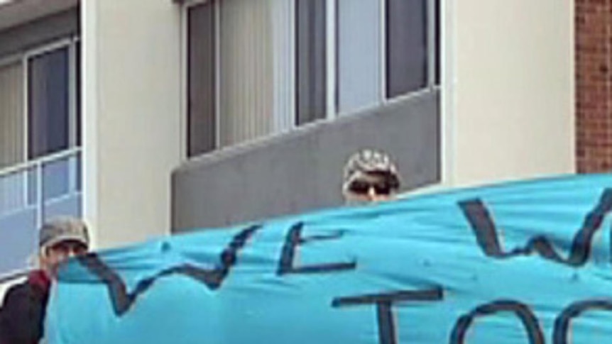 Protesters on roof of Chris Bowen's electorate office