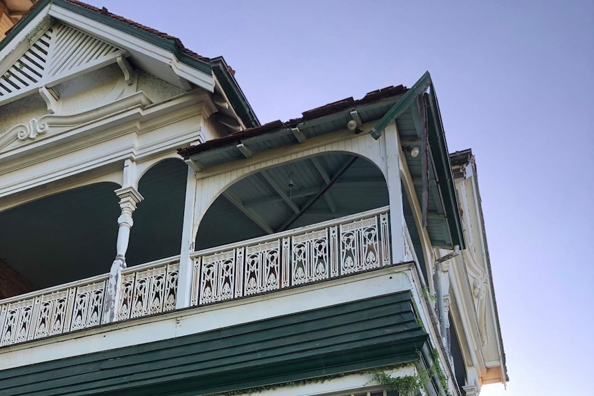 A mansion with a broken roof.