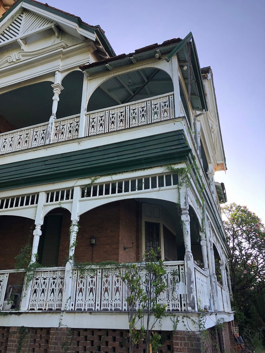 A mansion with a broken roof.