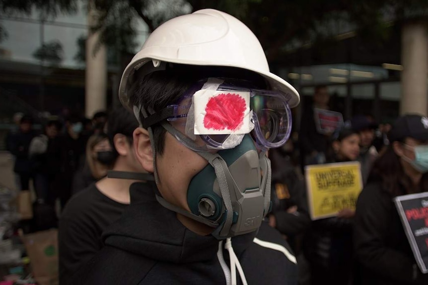 A pro-Hong Kong demonstrator wears a helmet and mask at an Adelaide rally.